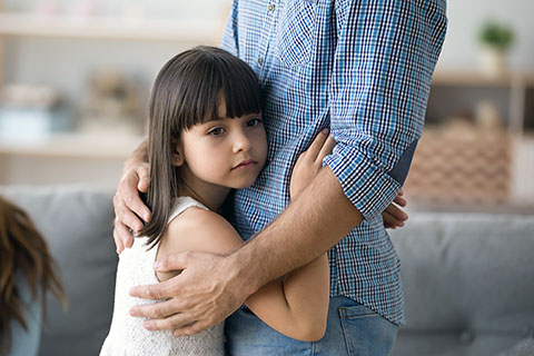 Co-parent father embracing daughter
