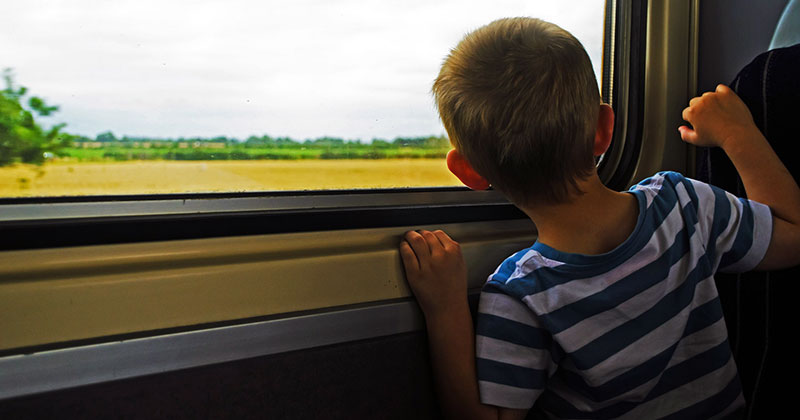 Boy looking out train window