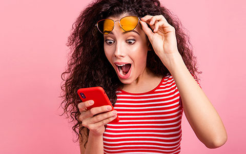 Woman surprised at what's on her mobile phone